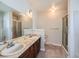 Bathroom featuring a double sink vanity with a marble countertop and a glass-enclosed shower at 1467 S Kenton St, Aurora, CO 80012