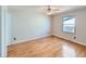 Bedroom with wood flooring and large window providing ample natural light at 1467 S Kenton St, Aurora, CO 80012