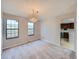 Bright dining room featuring neutral walls, plush carpet, chandelier and an adjacent kitchen at 1467 S Kenton St, Aurora, CO 80012