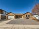 Attractive single-story brick home featuring a spacious two-car garage and a simple rock garden at 1467 S Kenton St, Aurora, CO 80012