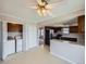 Bright kitchen with dark cabinetry, a breakfast bar, a laundry closet, and a view of the dining room at 1467 S Kenton St, Aurora, CO 80012