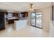 Eat-in kitchen features wood cabinetry, a breakfast bar, and a sliding glass door to the backyard at 1467 S Kenton St, Aurora, CO 80012