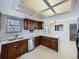 Functional kitchen featuring oak cabinets, stainless steel dishwasher and a pass-through window at 1467 S Kenton St, Aurora, CO 80012