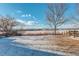 Snowy backyard with a view of a distant landscape at 1267 Bluejay Ave, Brighton, CO 80601