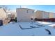 Spacious backyard with a snow-covered patio and garden at 1267 Bluejay Ave, Brighton, CO 80601