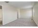 Simple bedroom with neutral walls, carpet flooring, and an ensuite bathroom at 1267 Bluejay Ave, Brighton, CO 80601