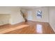 Bright living room with hardwood floors and stairs to the second floor at 1267 Bluejay Ave, Brighton, CO 80601