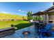 Green backyard with a patio including a fire pit, outdoor furniture, a green lawn, and fence at 15647 Weaver Gulch Dr, Morrison, CO 80465