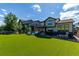 Backyard with spacious yard, patio, hot tub, green grass, landscaping and fences at 15647 Weaver Gulch Dr, Morrison, CO 80465