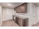 Basement bar area has sleek cabinets, a mini fridge, and a stylish countertop, perfect for entertaining guests at 15647 Weaver Gulch Dr, Morrison, CO 80465