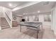 Spacious finished basement with ping pong table, carpeting, and natural light from egress windows at 15647 Weaver Gulch Dr, Morrison, CO 80465