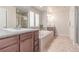 This bathroom features a soaking tub, dual sinks and a glass enclosed shower at 15647 Weaver Gulch Dr, Morrison, CO 80465
