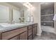 Double vanity bathroom boasts modern fixtures, a sleek countertop, and a tiled shower/tub combo at 15647 Weaver Gulch Dr, Morrison, CO 80465