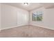 Bright bedroom featuring a large window, carpet flooring, and closet with sliding doors at 15647 Weaver Gulch Dr, Morrison, CO 80465