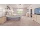 Bright bedroom with neutral paint, carpet flooring, natural light from the window, and a TV at 15647 Weaver Gulch Dr, Morrison, CO 80465