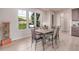 Bright dining area with views to a backyard, modern lighting, and seating for six at 15647 Weaver Gulch Dr, Morrison, CO 80465