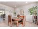 Bright dining room featuring an oval wood table, seating for four, and modern decor at 15647 Weaver Gulch Dr, Morrison, CO 80465