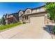 Charming two-story house with stone details, a paved driveway, and a well-kept lawn at 15647 Weaver Gulch Dr, Morrison, CO 80465