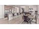 Open kitchen and dining area with stainless steel appliances, granite countertops, and a breakfast bar at 15647 Weaver Gulch Dr, Morrison, CO 80465
