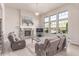 Cozy living room featuring a stone fireplace, large windows, and comfortable seating at 15647 Weaver Gulch Dr, Morrison, CO 80465