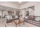 Open-concept living room with hardwood floors, comfortable couches, and ample space at 15647 Weaver Gulch Dr, Morrison, CO 80465