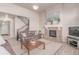 Comfortable living room featuring a stone fireplace, staircase, and cozy seating at 15647 Weaver Gulch Dr, Morrison, CO 80465