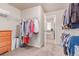 Walk-in closet that has shelving and built in racks for optimal storage at 15647 Weaver Gulch Dr, Morrison, CO 80465