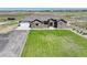 Single-story home with a large yard, driveway and detached barn at 45425 Wolf Creek Dr, Bennett, CO 80102