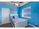 Bedroom with white bed frame, blue walls, and a large window at 45425 Wolf Creek Dr, Bennett, CO 80102