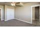 Bright bedroom with double doors to closet and access to bathroom at 45425 Wolf Creek Dr, Bennett, CO 80102