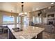 Gourmet kitchen with granite island, double sink and stainless steel appliances at 45425 Wolf Creek Dr, Bennett, CO 80102