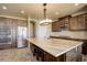 Spacious kitchen with large island, double oven and dark wood cabinets at 45425 Wolf Creek Dr, Bennett, CO 80102