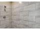 Modern shower with gray tile surround at 45425 Wolf Creek Dr, Bennett, CO 80102