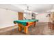 Basement recreation room with pool table, fireplace, and TV at 6119 Zenobia Ct, Arvada, CO 80003