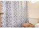 Clean bathroom with toilet and shower with patterned curtain at 6119 Zenobia Ct, Arvada, CO 80003