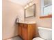 Clean bathroom with wood vanity and updated fixtures at 6119 Zenobia Ct, Arvada, CO 80003