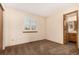 Simple bedroom with carpet flooring and access to bathroom at 6119 Zenobia Ct, Arvada, CO 80003