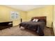 Spacious bedroom with dark brown carpeting and a large bed at 6119 Zenobia Ct, Arvada, CO 80003