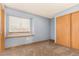 Bright bedroom with window seat, built-in closet, and carpet flooring at 6119 Zenobia Ct, Arvada, CO 80003