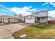 Two-story house with a two-car garage, light siding, and well-kept lawn at 6119 Zenobia Ct, Arvada, CO 80003