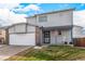 Two-story house with attached garage and rocking chair on porch at 6119 Zenobia Ct, Arvada, CO 80003