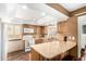 Well-lit kitchen with wooden cabinets, a large island, and modern appliances at 6119 Zenobia Ct, Arvada, CO 80003