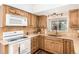 Modern kitchen with wood cabinets, granite countertops and a built-in microwave at 6119 Zenobia Ct, Arvada, CO 80003