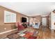 Living room with hardwood floors, large TV, and comfy seating at 6119 Zenobia Ct, Arvada, CO 80003