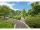 Beautiful backyard features a stone gravel path and shed surrounded by lush greenery at 9158 Forest St, Firestone, CO 80504