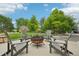 Landscaped backyard features a circular stone fire pit with Adirondack chairs at 9158 Forest St, Firestone, CO 80504