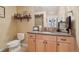 Bathroom featuring a wooden vanity with granite countertop and nearby toilet at 9158 Forest St, Firestone, CO 80504