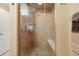 Walk-in shower featuring decorative tiling, seating, and overhead lighting at 9158 Forest St, Firestone, CO 80504