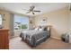 Cozy bedroom featuring a ceiling fan, window, and neutral decor at 9158 Forest St, Firestone, CO 80504