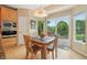 Cozy dining area with natural light, table setting, and access to the outdoor patio at 9158 Forest St, Firestone, CO 80504